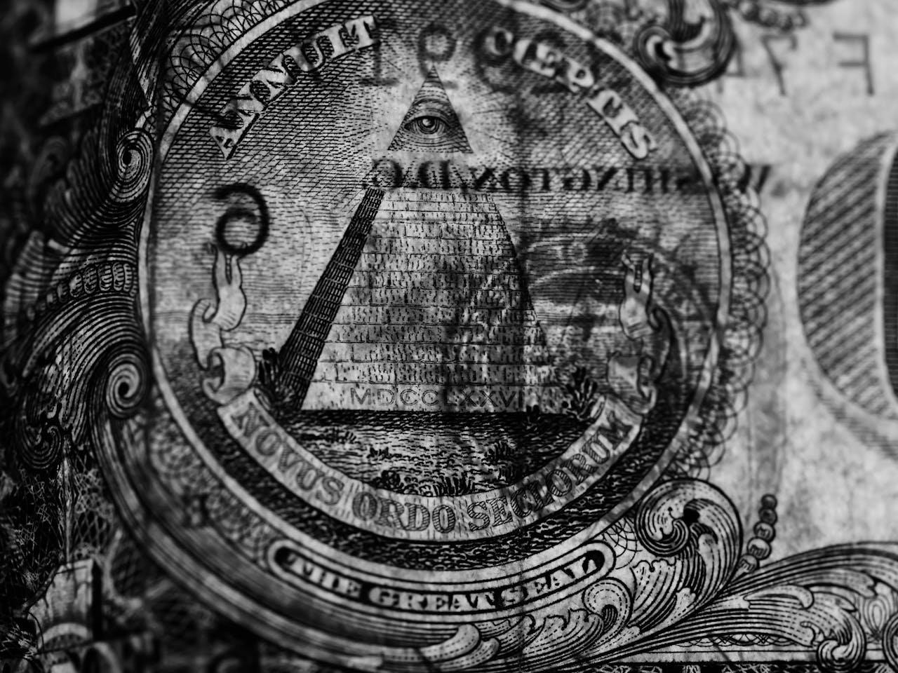 Detailed monochrome close-up of the Eye of Providence on a US dollar bill, emphasizing texture.